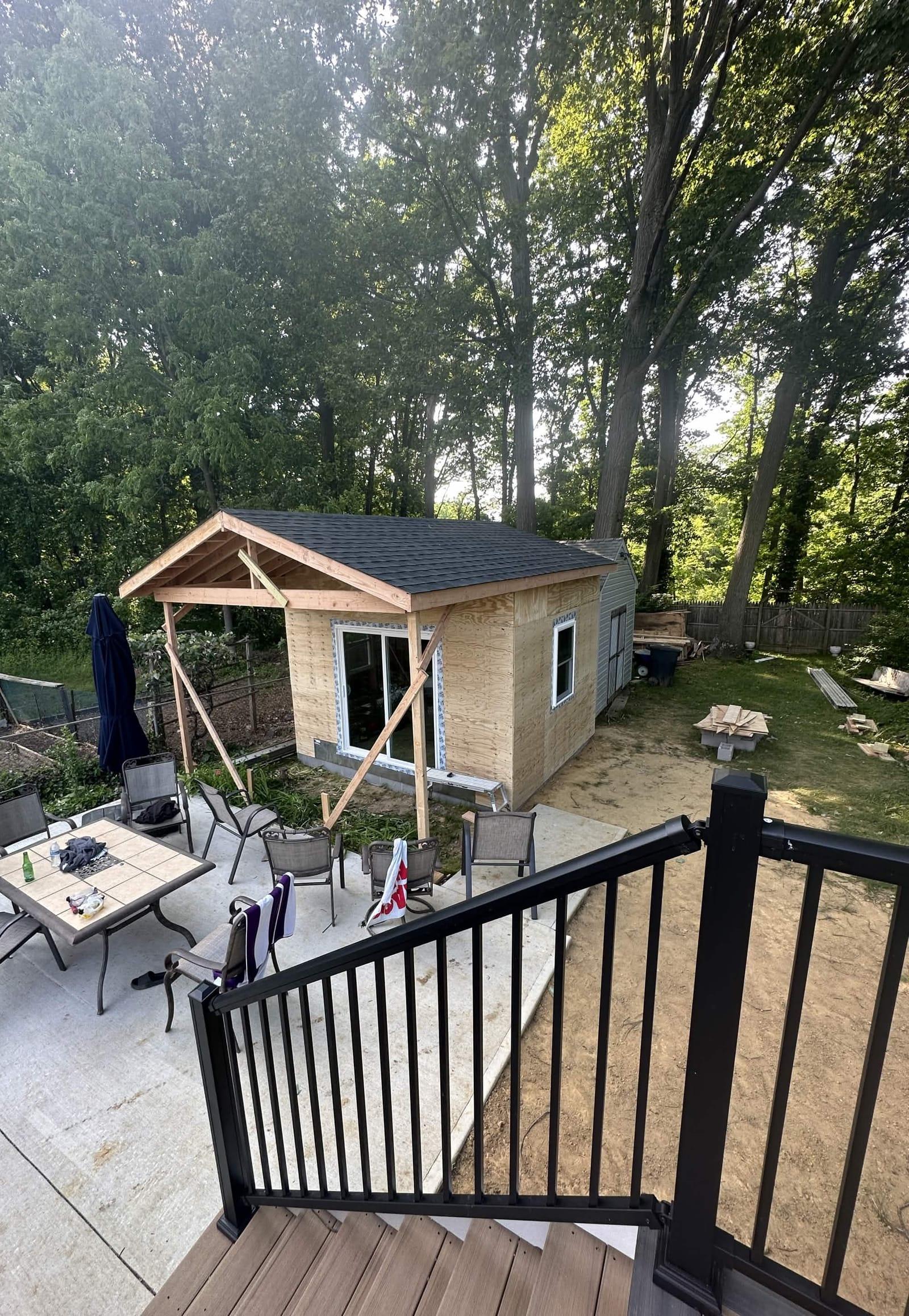 Shingled roof and sliding door installed on custom pool house build