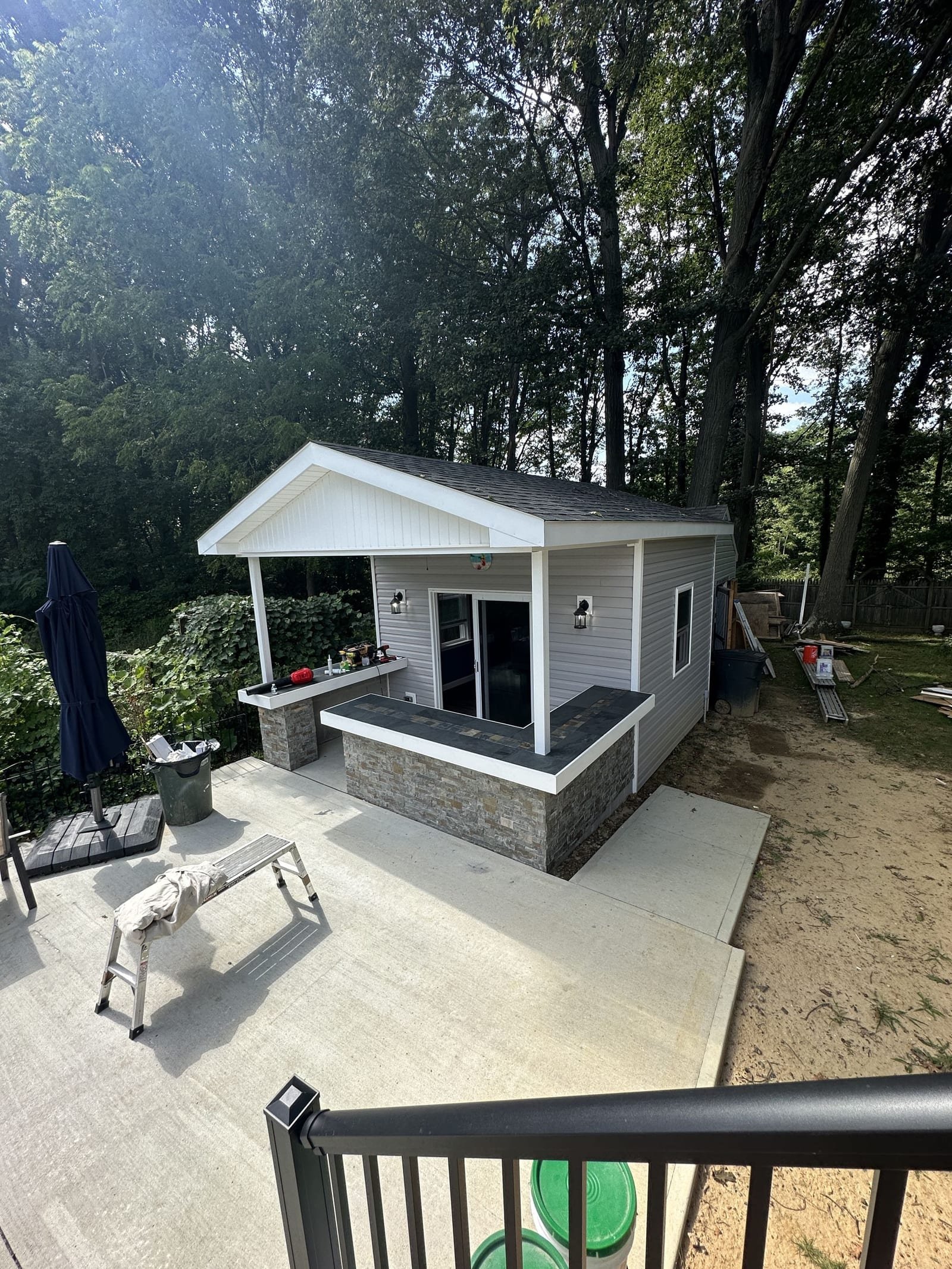Finished pool house with stone outdoor bar and covered porch in Monmouth County NJ